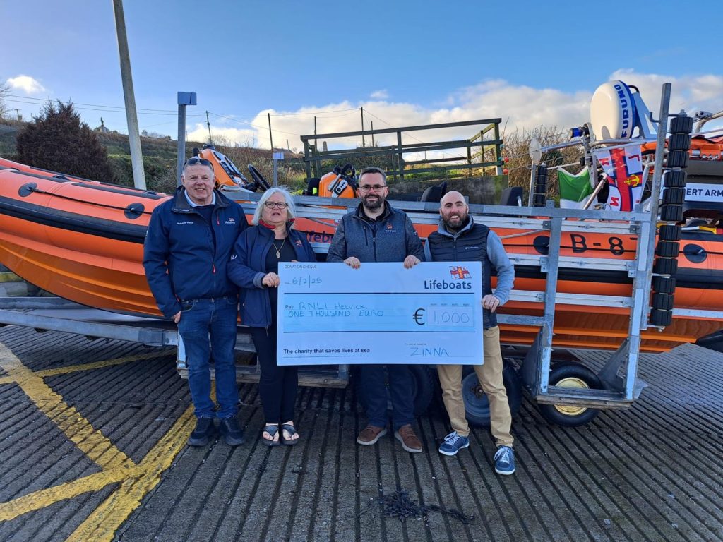 RNLI's Liam Harty & Dolores Walsh with Benny Barry & Eric Denmead from Zinnia Ltd present €1000 donation on Feb 6th 2025 at RNLI Helvick lifeboat station